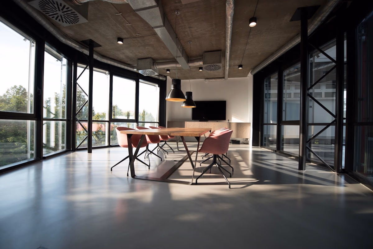 Modern corporate meeting room with large windows showing office blinds in Dubai